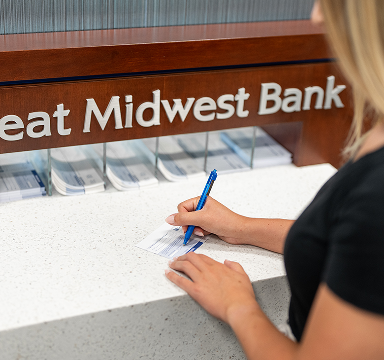 woman signing bank deposit slip