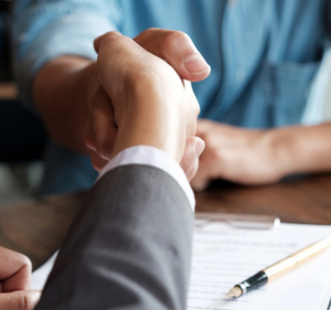 handshake over mortgage paperwork